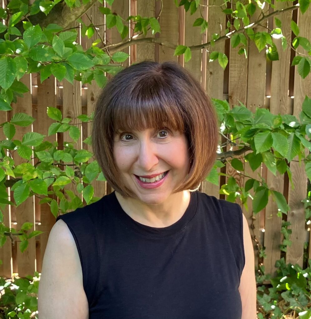 White woman with brown hair wearing a black shirt